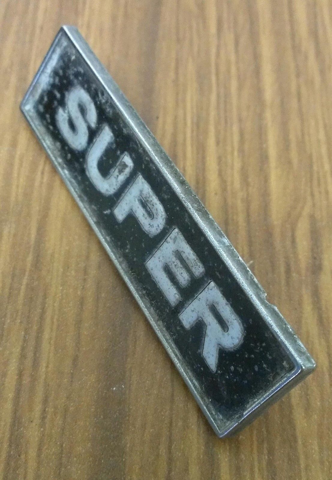 Super car block badge, fair condition, 2.6 inches long, prongs intact.