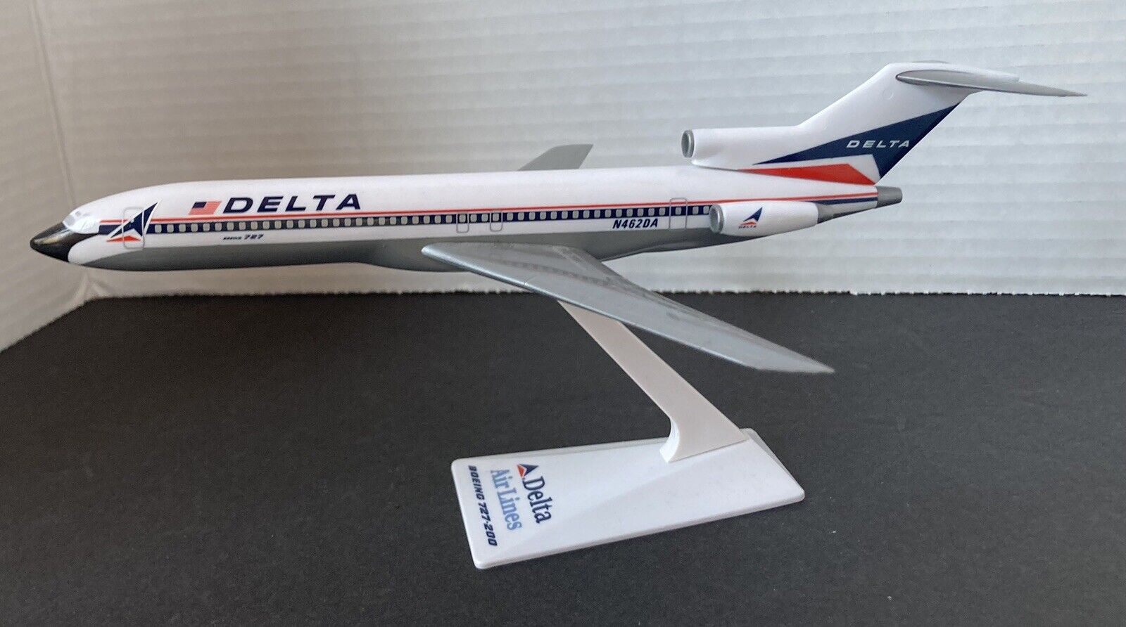 vintage 1980\'s Delta Air Lines 727-200 model on stand
